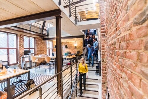 a lady walking on the stairs of a coworking space