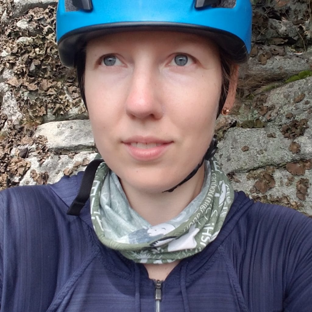 Jana Paremoud, a coworking member, wearing a helmet and blue bandana, poised for an adventurous journey outdoors.