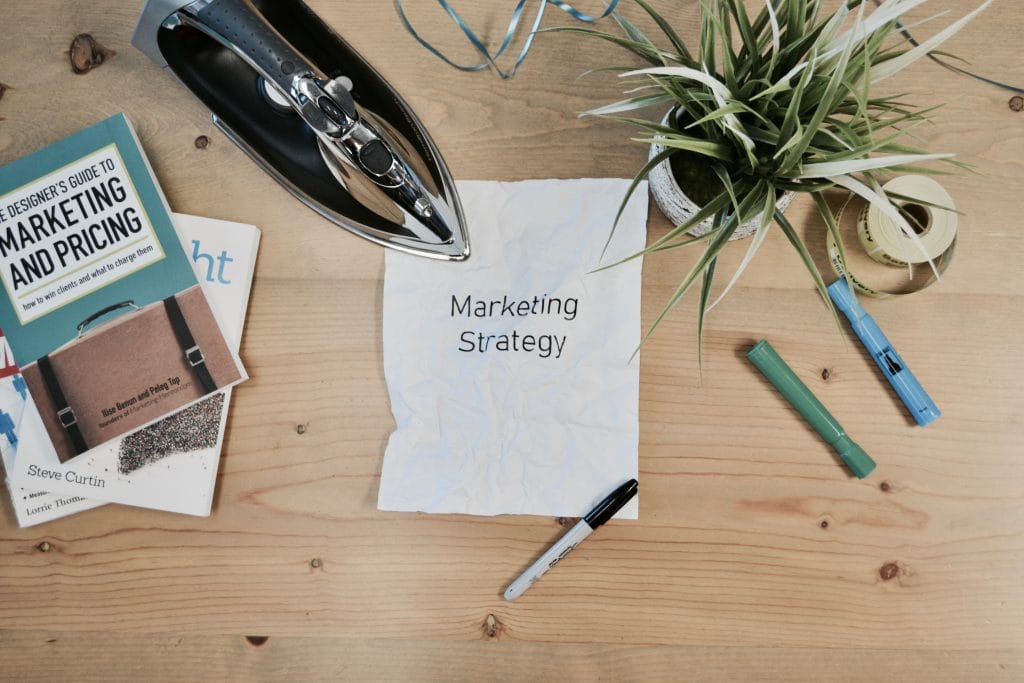 A wooden table displaying a marketing strategy document, emphasizing new-age marketing tips for #LiveCreateDay.
