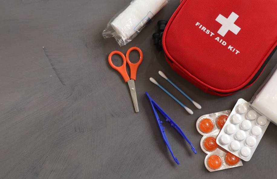 A first aid kit displayed on a table, highlighting its importance for digital nomads in emergency preparedness while traveling.