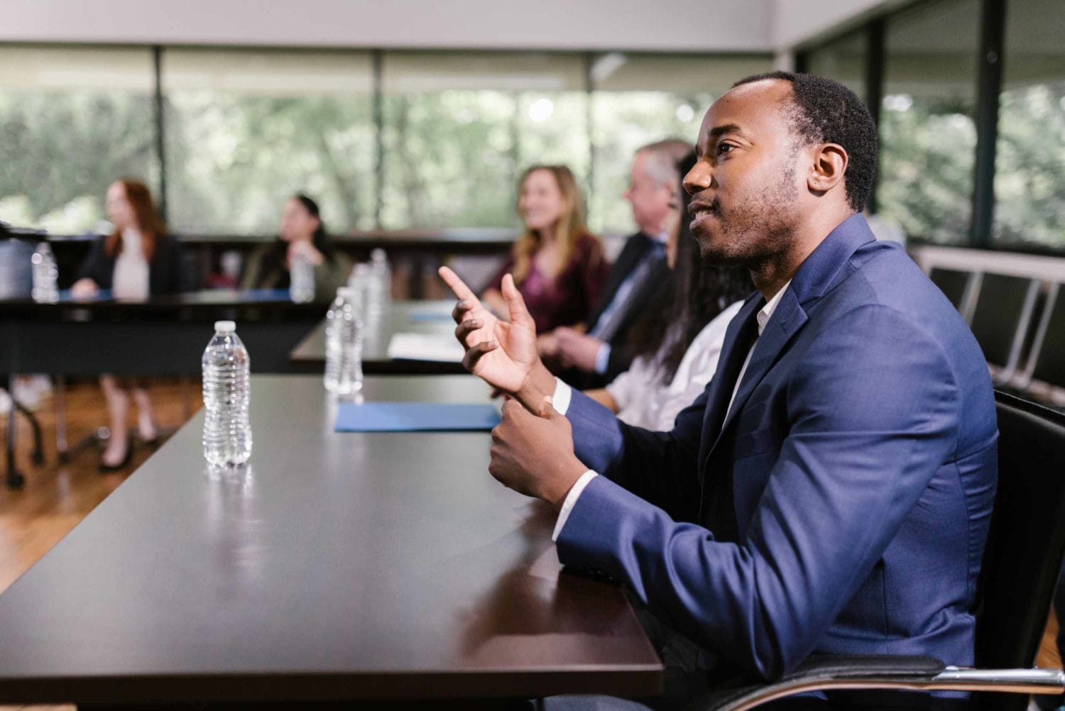 A professional man speaks to an audience, emphasizing the importance of corporate events for organizational success.