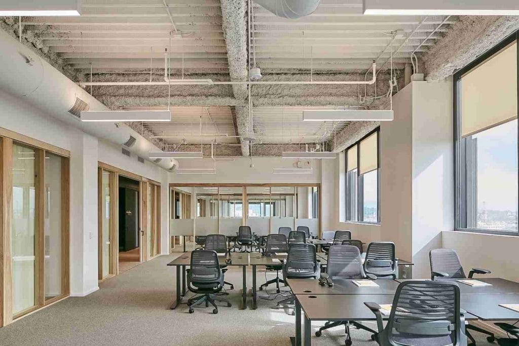 A large, open office space with multiple desks, exemplifying the dynamic coworking culture in Los Angeles.