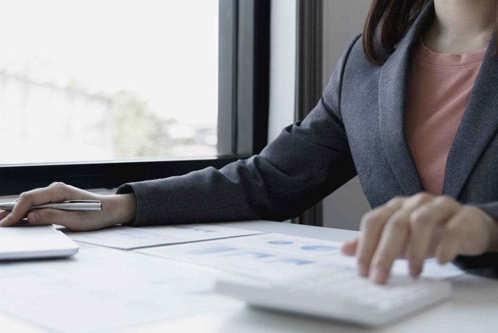 A woman in a business suit engaged with her laptop, illustrating the essence of entrepreneurship in the Pacific Northwest.