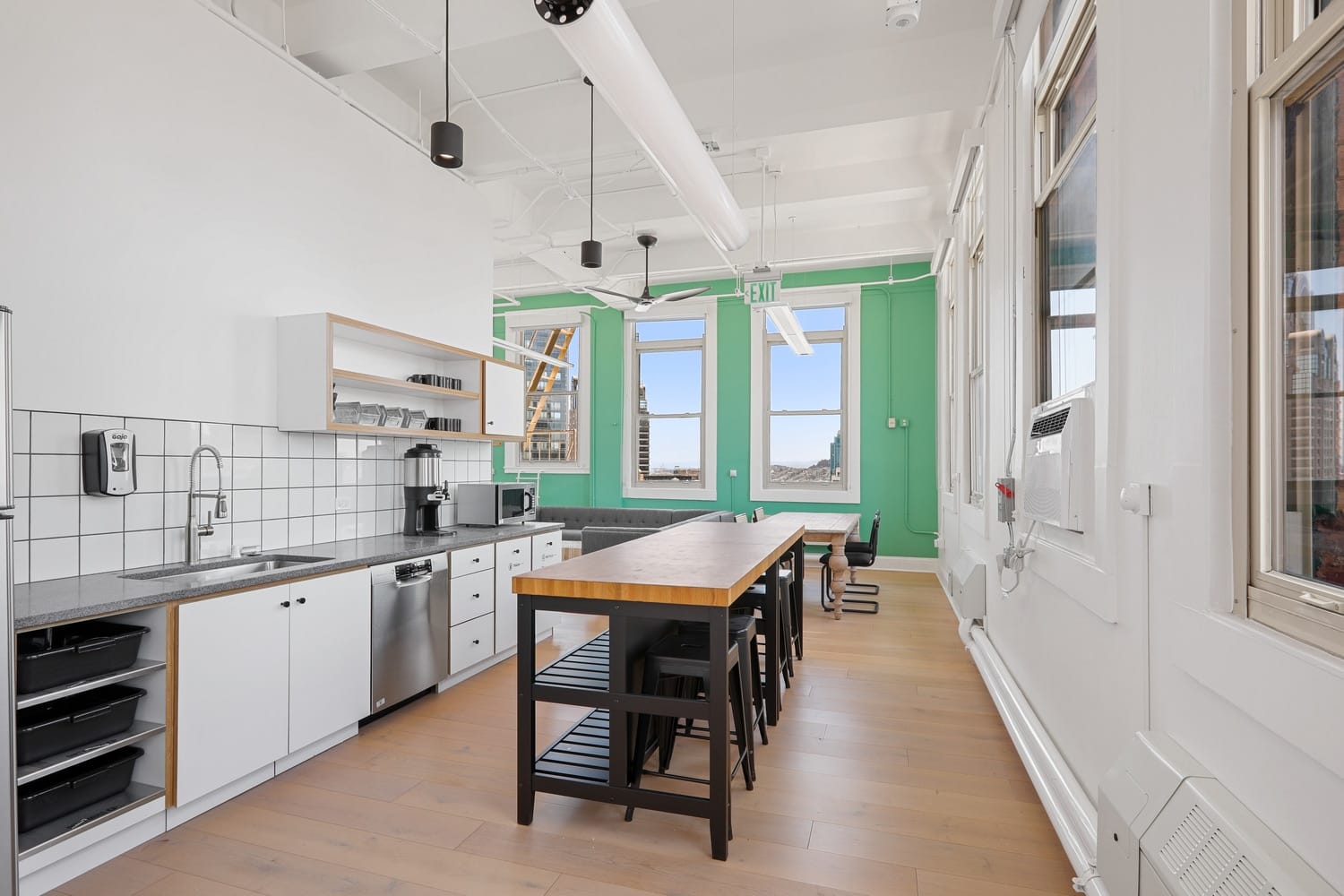 Contemporary kitchen with a stove, refrigerator, and bar stools, situated in San Francisco at 166 Geary.