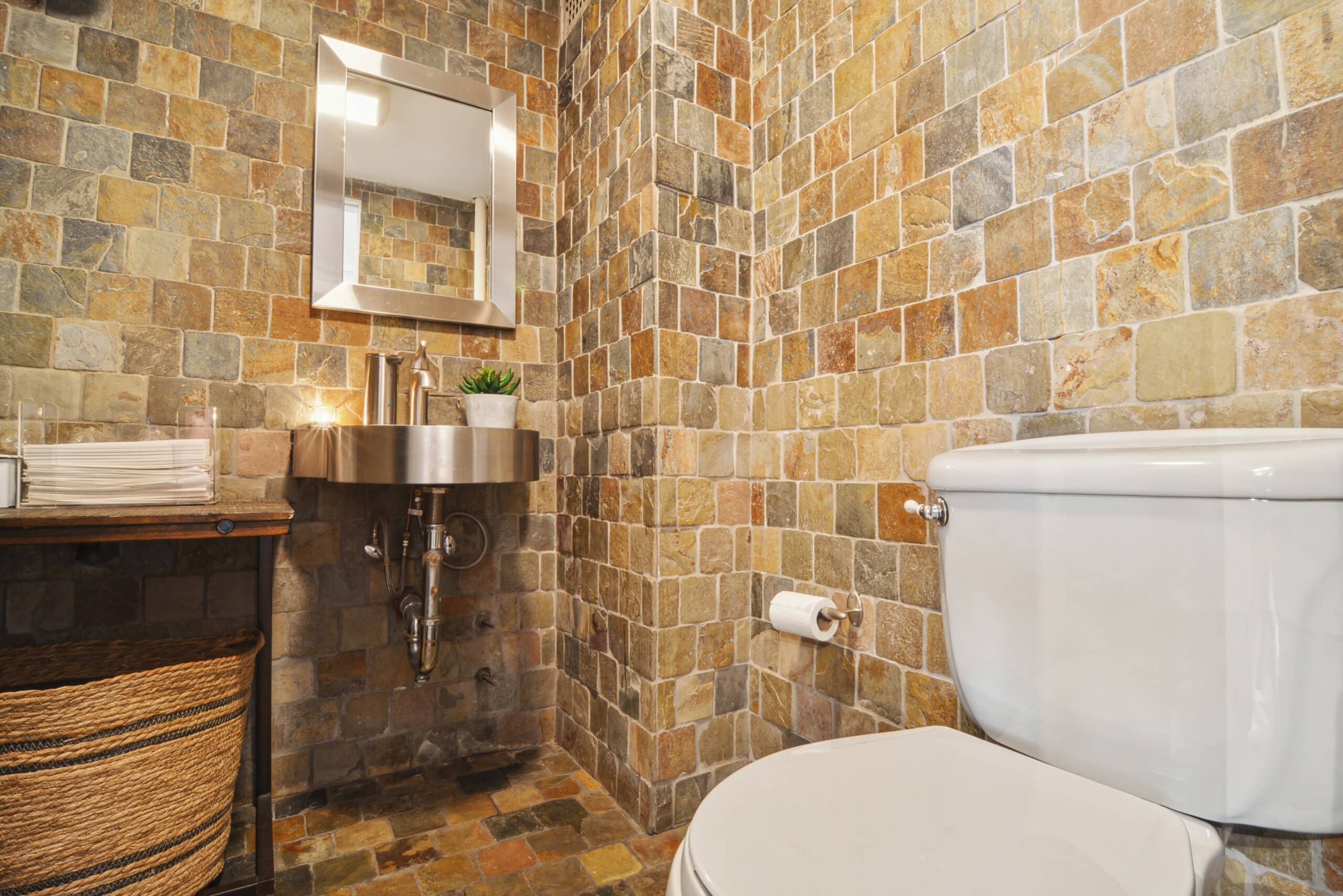 A well-appointed bathroom with a toilet, sink, and mirror, providing convenience for visitors at The Farm Soho venue.