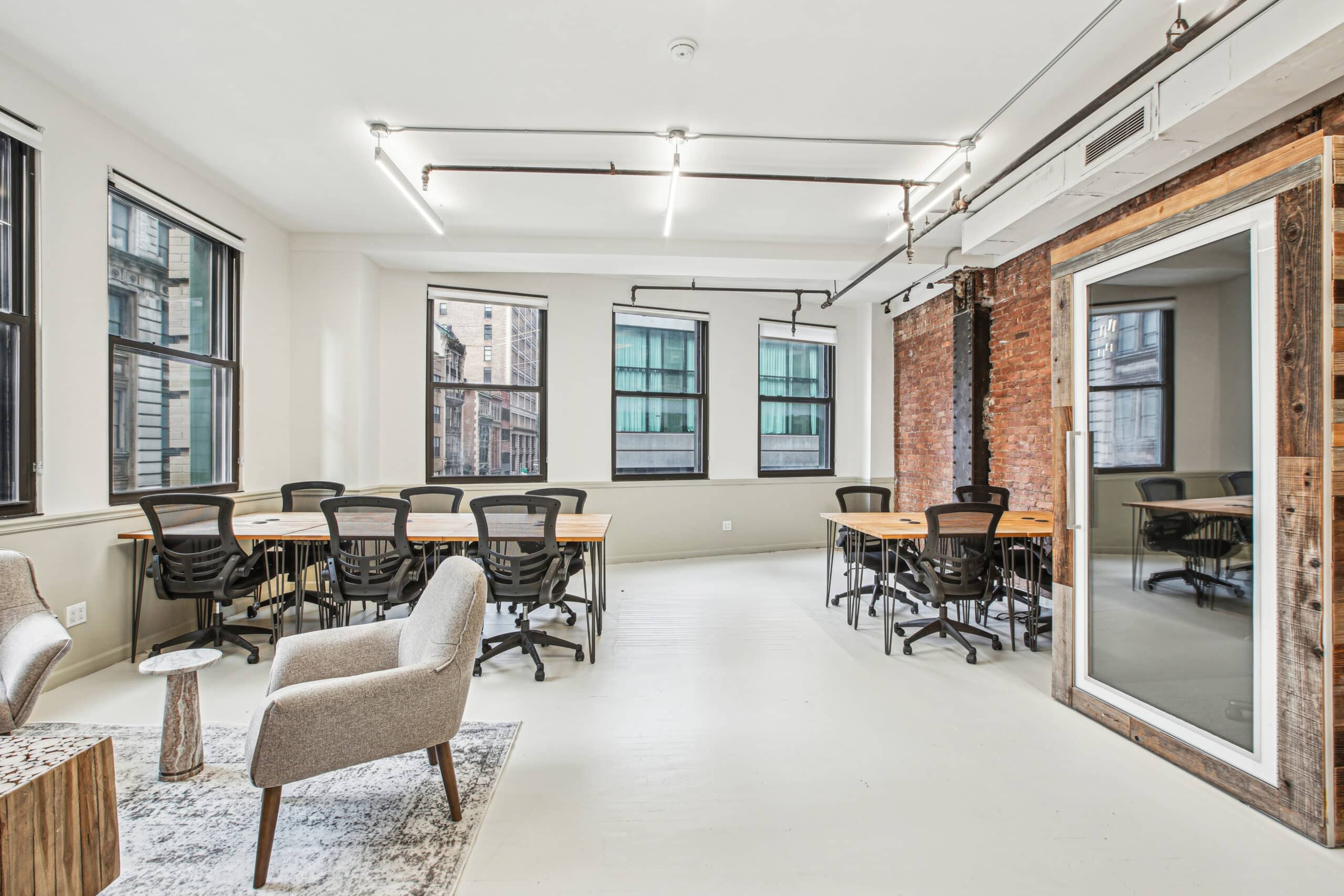 A well-lit office with a large window and a generous desk, promoting an efficient and inviting work atmosphere.